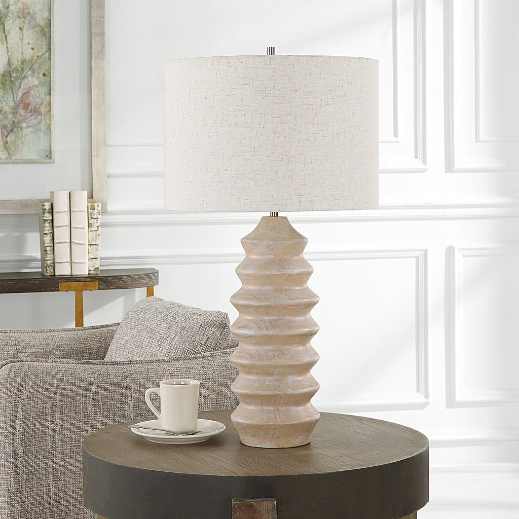 Introducing a captivating testament to modern sophistication. With a geometric carved base, featuring a stunning bleached wood tone look, this table lamp radiates timeless elegance.- Alternate Image