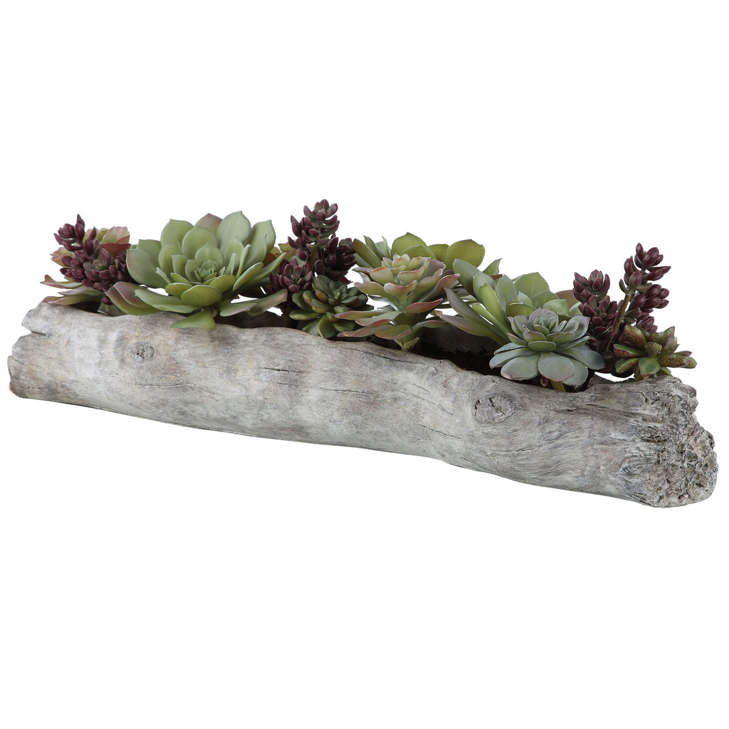 A Lush Mix Of Succulents In Varying Tones Of Greens And Burgundy Over A Faux Soil Mixture, Filling A Solid Concrete Container Resembling A Life-like Driftwood Log.- Alternate Image