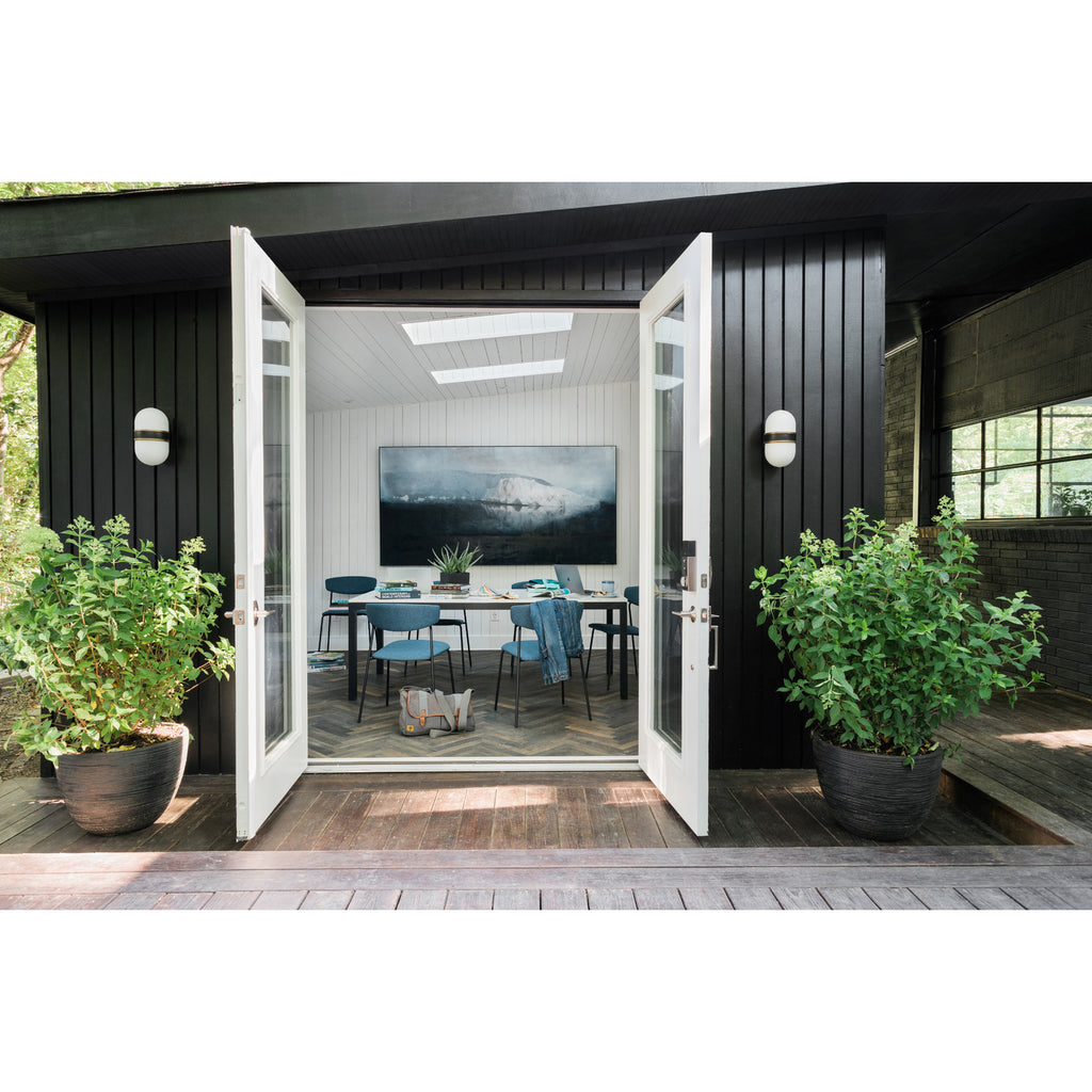 Crystorama Capsule 6'' Outdoor Sconce in Matte Black + Textured Gold - Lifestyle View
