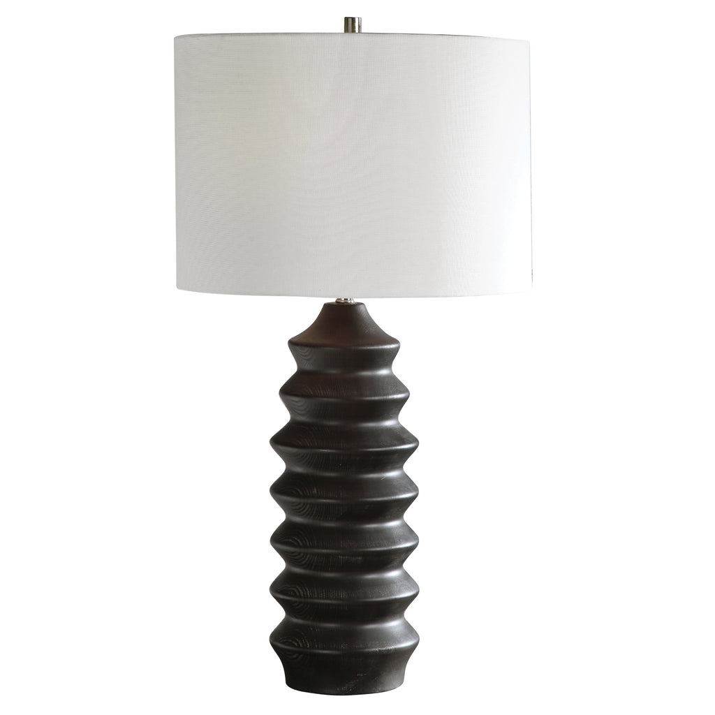 Experience the perfect fusion of modernity and lodge-inspired charm with our captivating table lamp. Crafted with meticulous attention to detail, its carved wood base exudes rustic elegance, enhanced by a lustrous black stain that gracefully reveals the subtle wood grain.